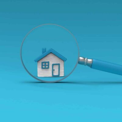 Maison sous une loupe bleue.
