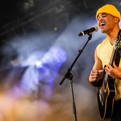 Chanteur sur scène avec une guitare.