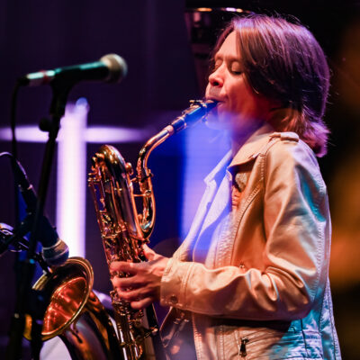 Musicien jouant du saxophone sur scène.
