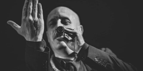 Chanteur en noir et blanc sur scène.