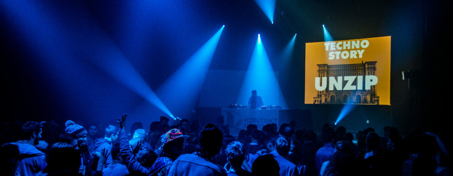 Ambiance en pleine fête électro pendant une soirée Techno Story, lumière sombre et public dansant.
