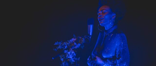 Chanteuse sur scène, éclairage bleu artistique