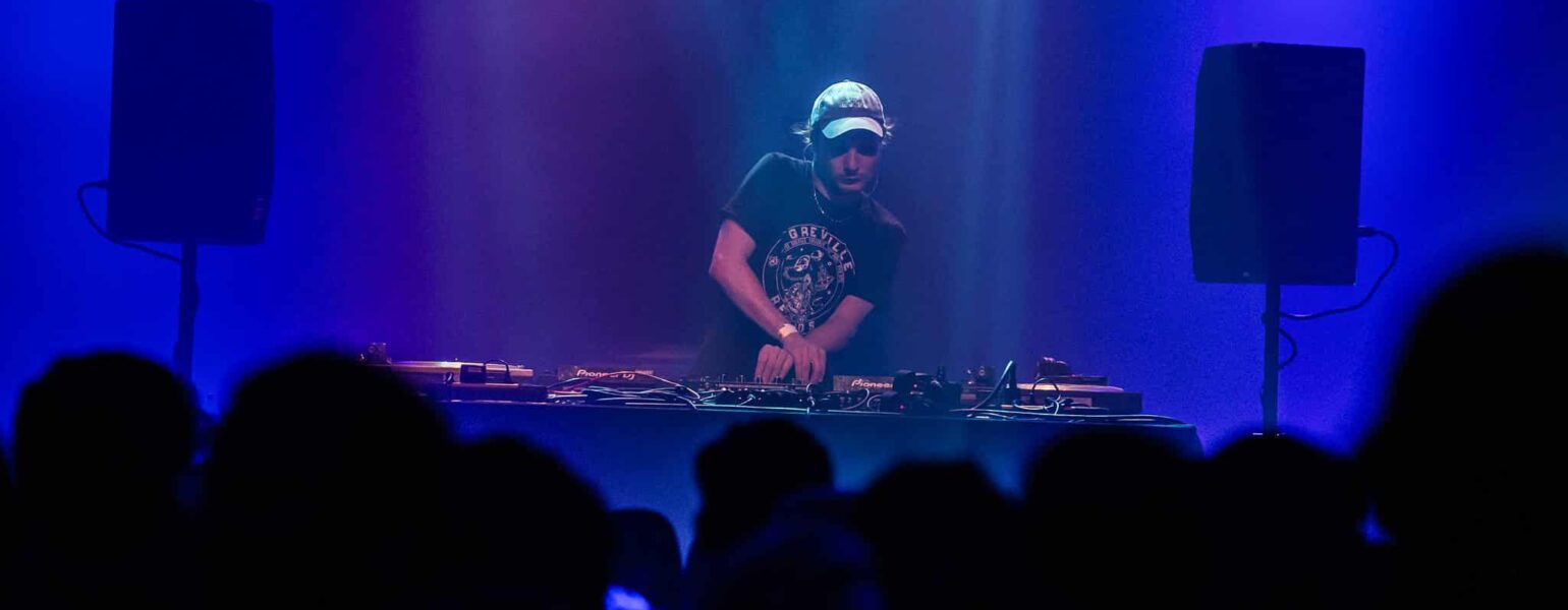 DJ mixant sur scène devant public.