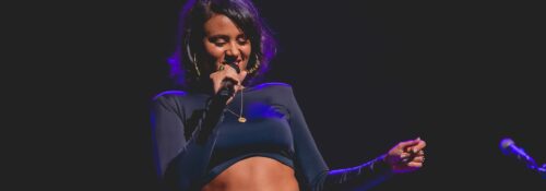 Femme chantant sur scène en concert.