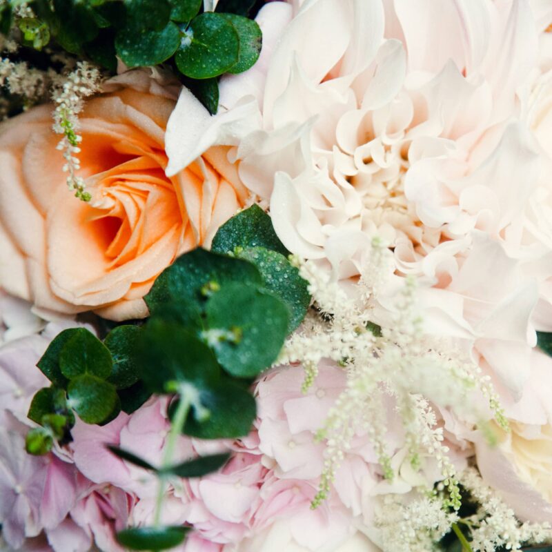 Bouquet de fleurs multicolores et feuillage vert.