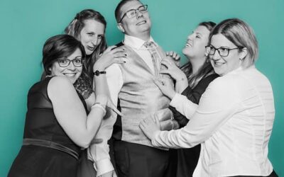 Cinq personnes souriantes, fond vert.