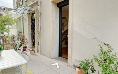 Terrasse moderne avec plantes et table extérieure.