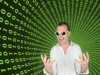 Homme heureux devant fond de code binaire vert.