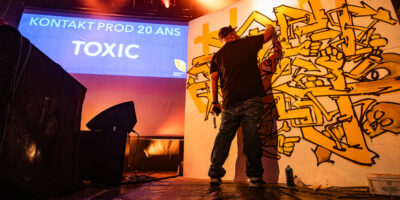 Artiste peignant graffiti lors d'un événement.