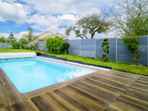Piscine extérieure avec terrasse en bois.
