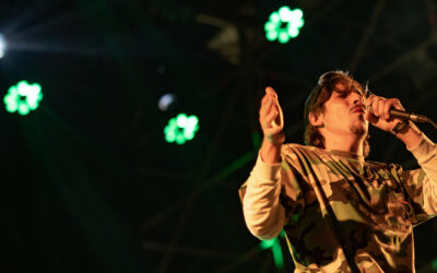 Portrait de Biga*Ranx en concert, mettant en avant son style unique mêlant dub et reggae, avec une ambiance lumineuse immersive.